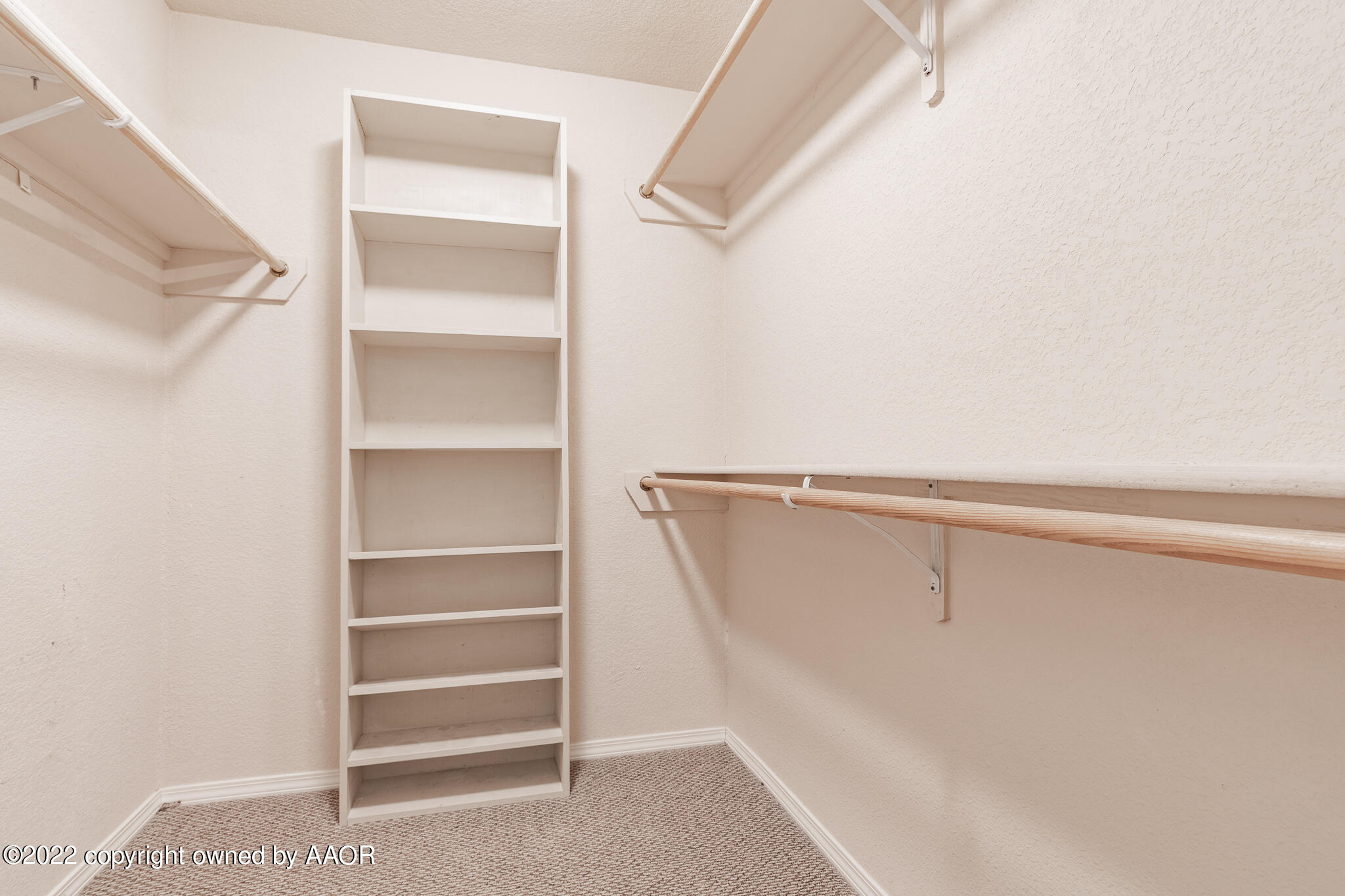 4726 Capulin Lane Amarillo, TX 79110 - Photo 16 of 28 a view of walk in closet with empty racks