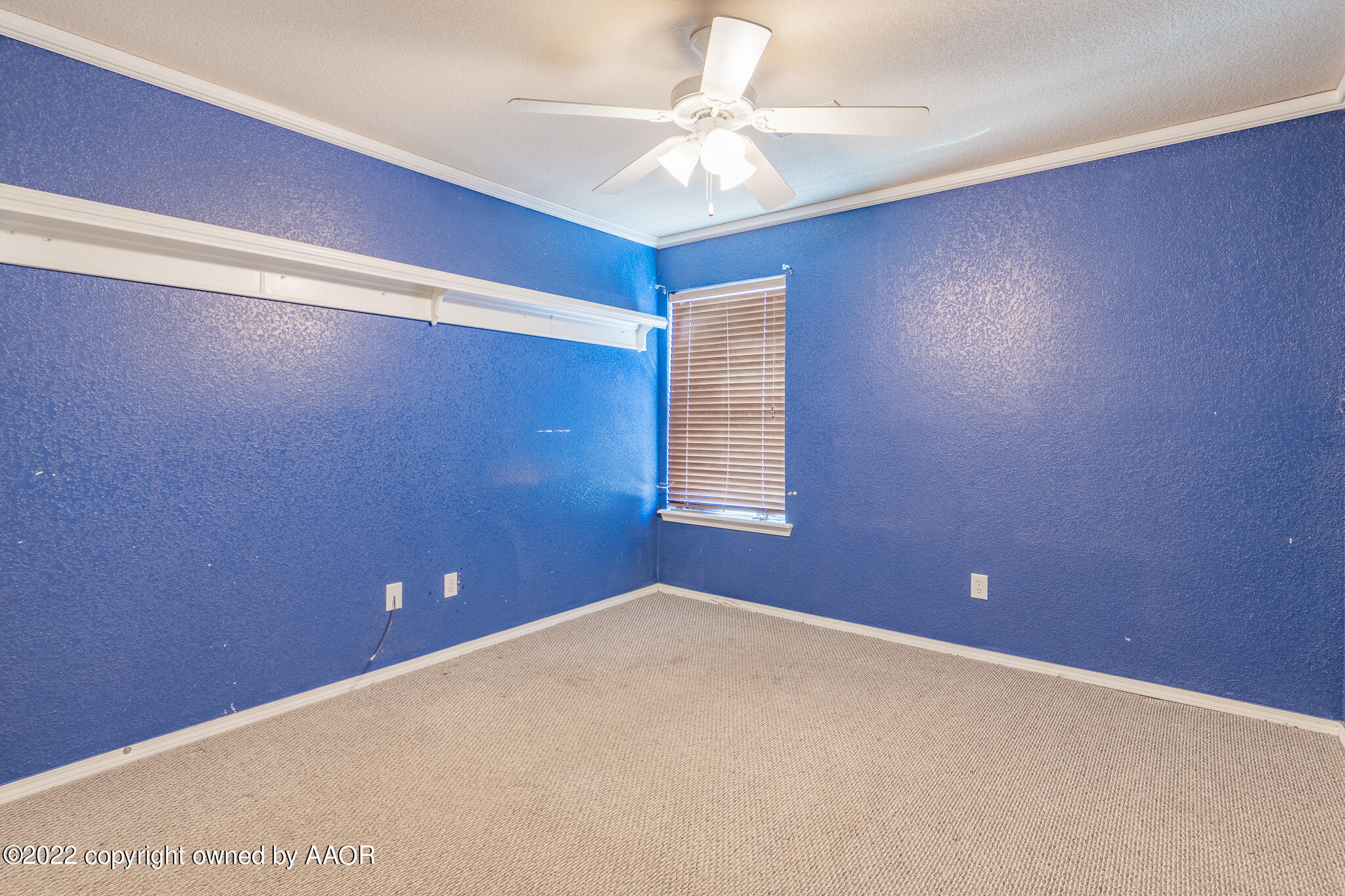 4726 Capulin Lane Amarillo, TX 79110 - Photo 18 of 28 en empty room with windows and fan