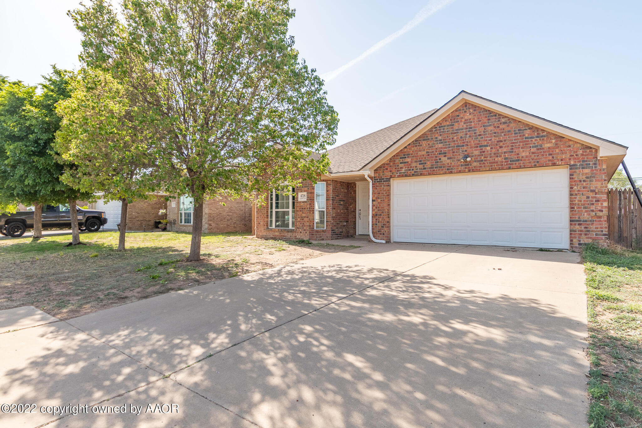 4726 Capulin Lane Amarillo, TX 79110 - Photo 2 of 28 a front view of a house with a yard and garage