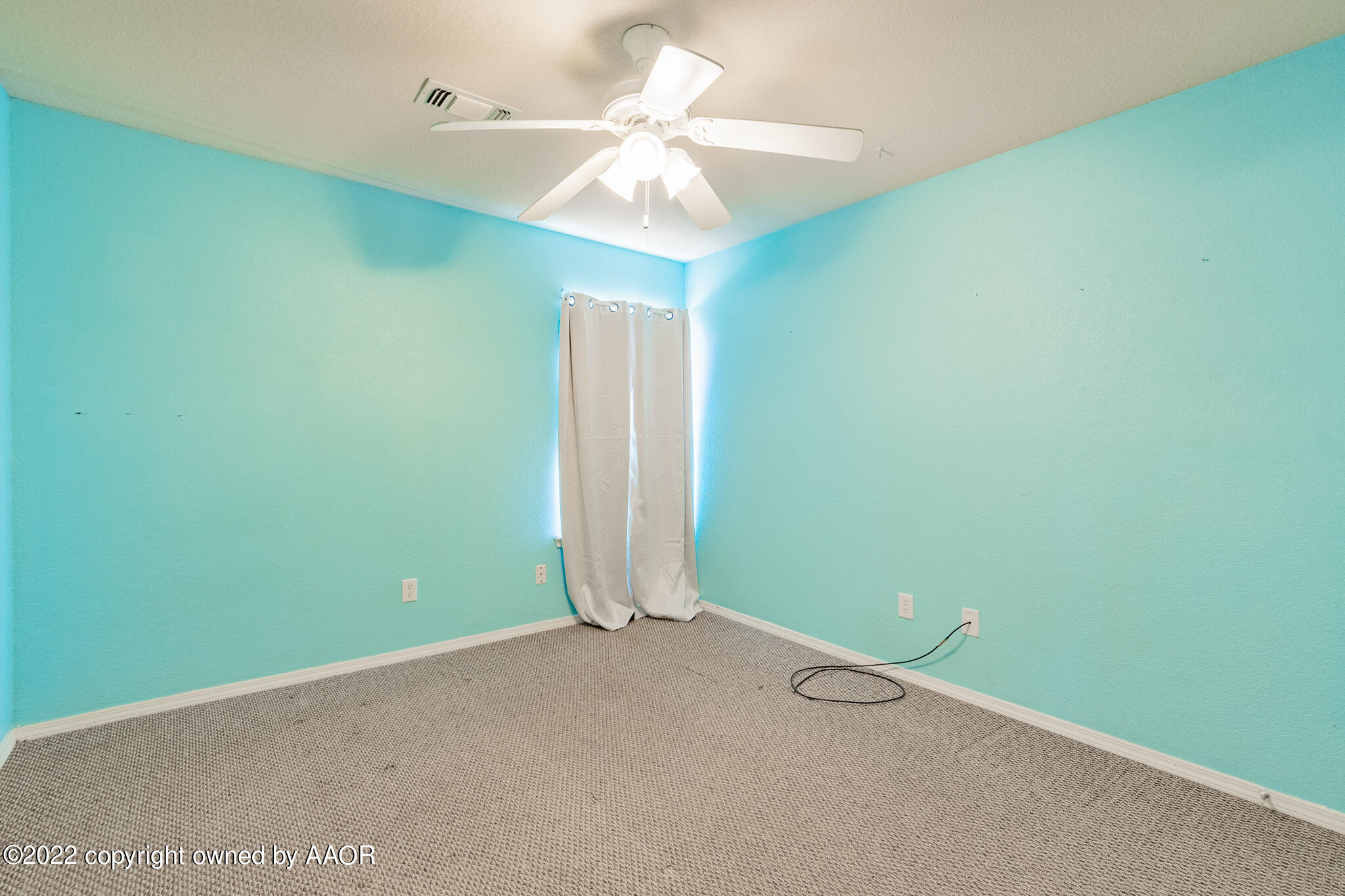 4726 Capulin Lane Amarillo, TX 79110 - Photo 22 of 28 an empty room with a fan and a ceiling fan
