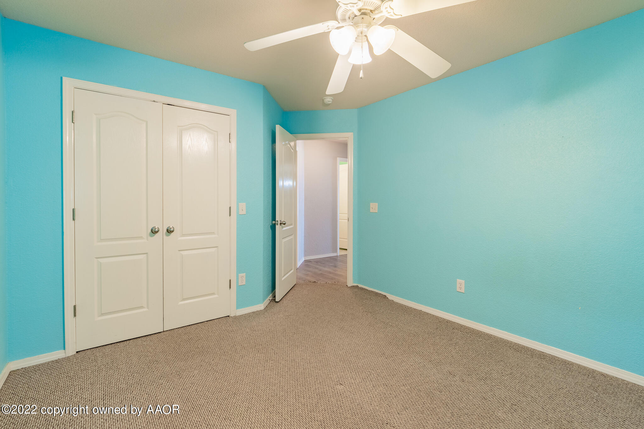 4726 Capulin Lane Amarillo, TX 79110 - Photo 26 of 28 an empty room with a fan and a chandelier fan