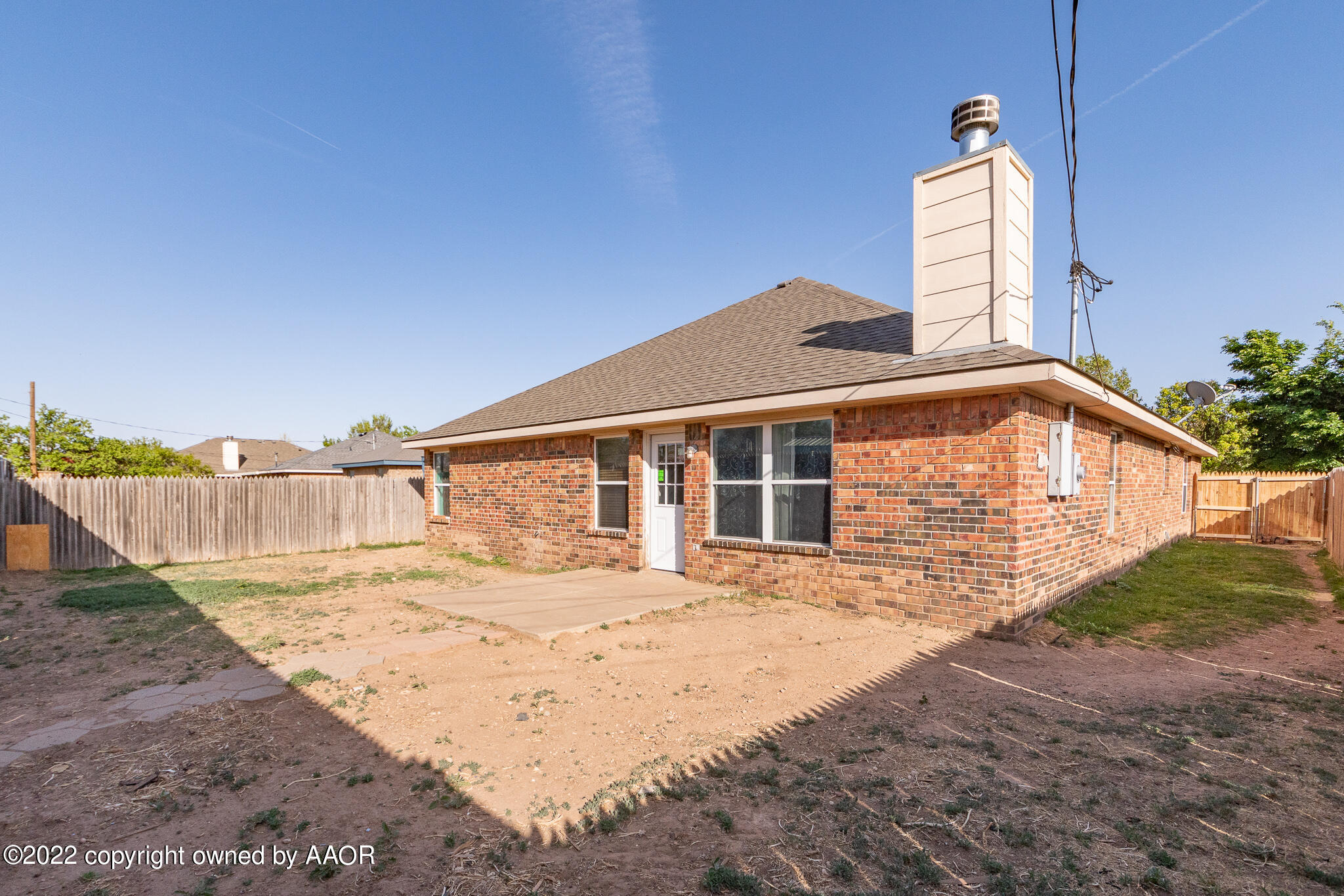 4726 Capulin Lane Amarillo, TX 79110 - Photo 27 of 28 a backyard of a house with wooden fence and large trees