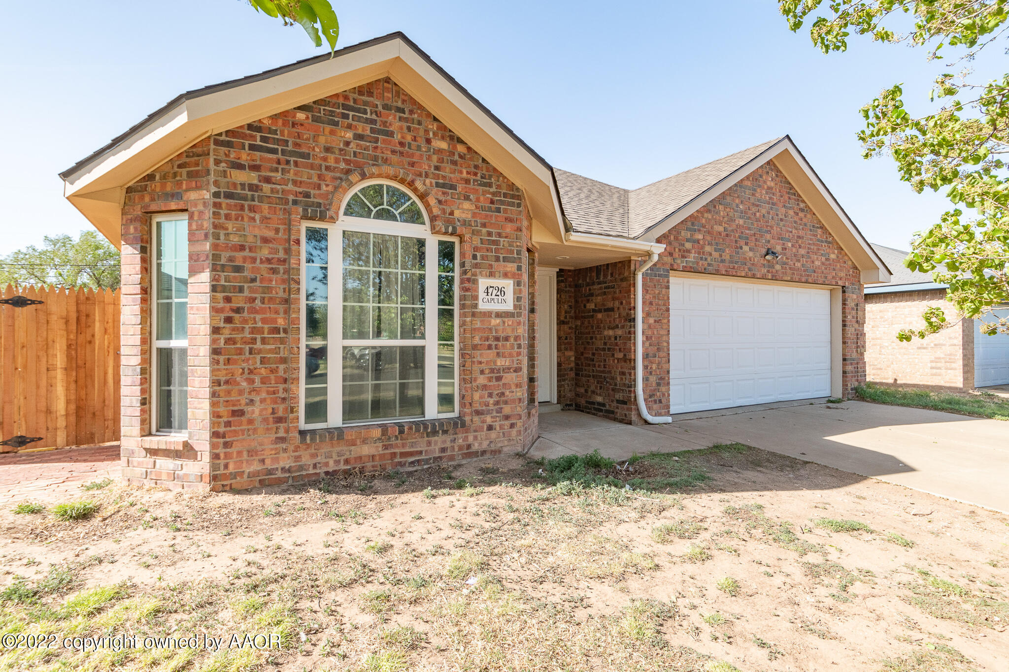 4726 Capulin Lane Amarillo, TX 79110 - Photo 4 of 28 a front view of a house with a yard and garage