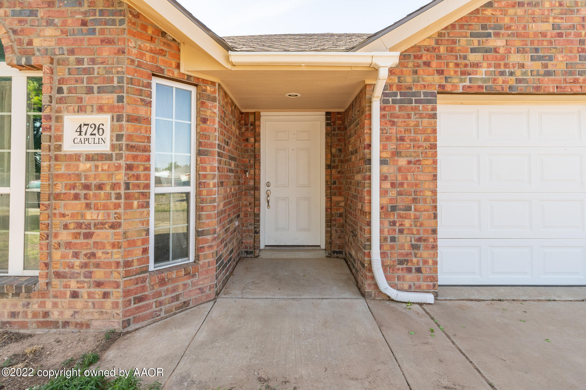 4726 Capulin Lane Amarillo, TX 79110 - Photo 5 of 28 front view of a brick house with windows