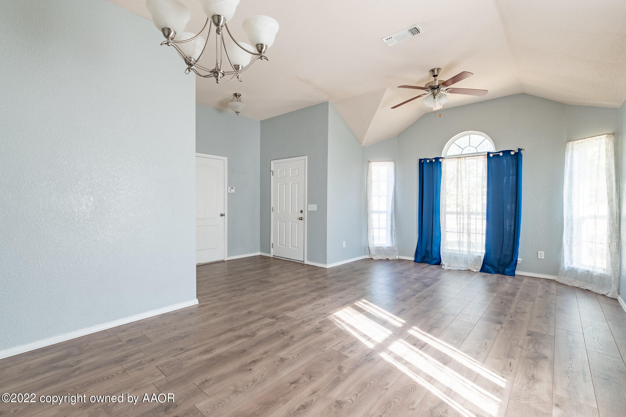 4726 Capulin Lane Amarillo, TX 79110 - Photo 7 of 28 a view of a chandelier fan and entryway with wooden floor