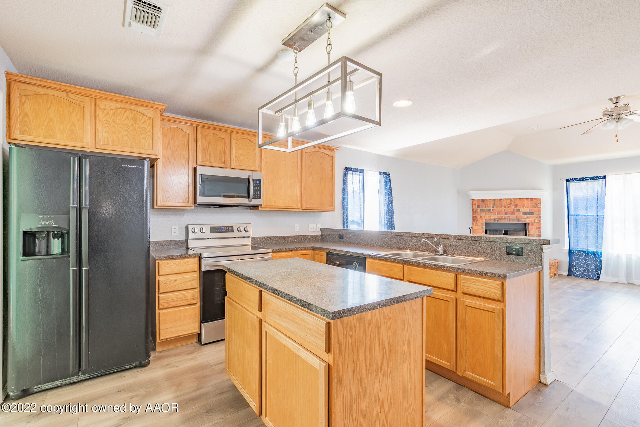 4726 Capulin Lane Amarillo, TX 79110 - Photo 9 of 28 a kitchen with stainless steel appliances granite countertop a sink stove and refrigerator