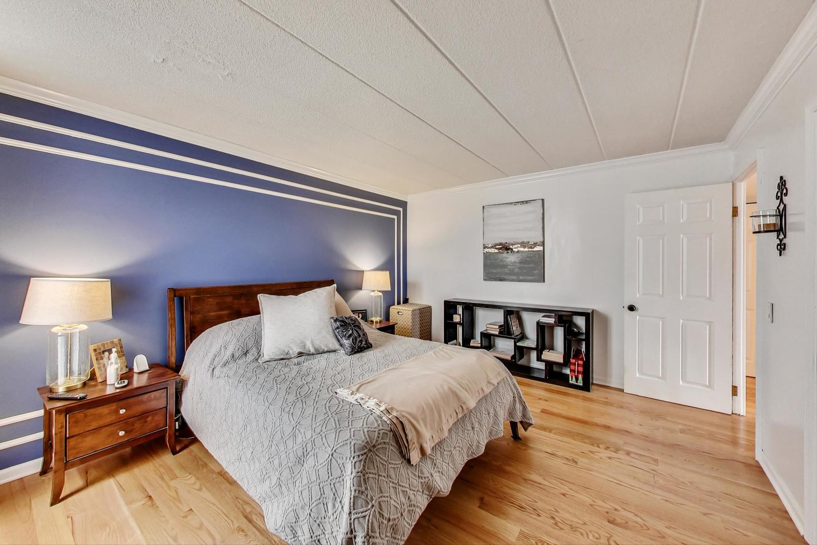 651 West Sheridan Road, Unit 7C Chicago, IL 60613 - Photo 15 of 27 a bed room with a bed and a night stand