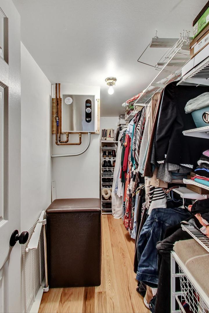 651 West Sheridan Road, Unit 7C Chicago, IL 60613 - Photo 16 of 27 a view of walk in closet with clothes and shoes