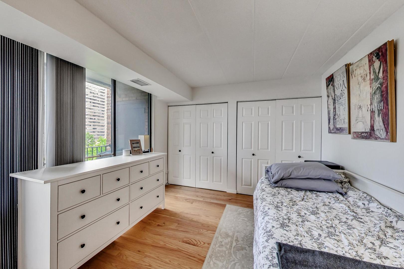 651 West Sheridan Road, Unit 7C Chicago, IL 60613 - Photo 20 of 27 a bedroom with a bed and a dresser in it