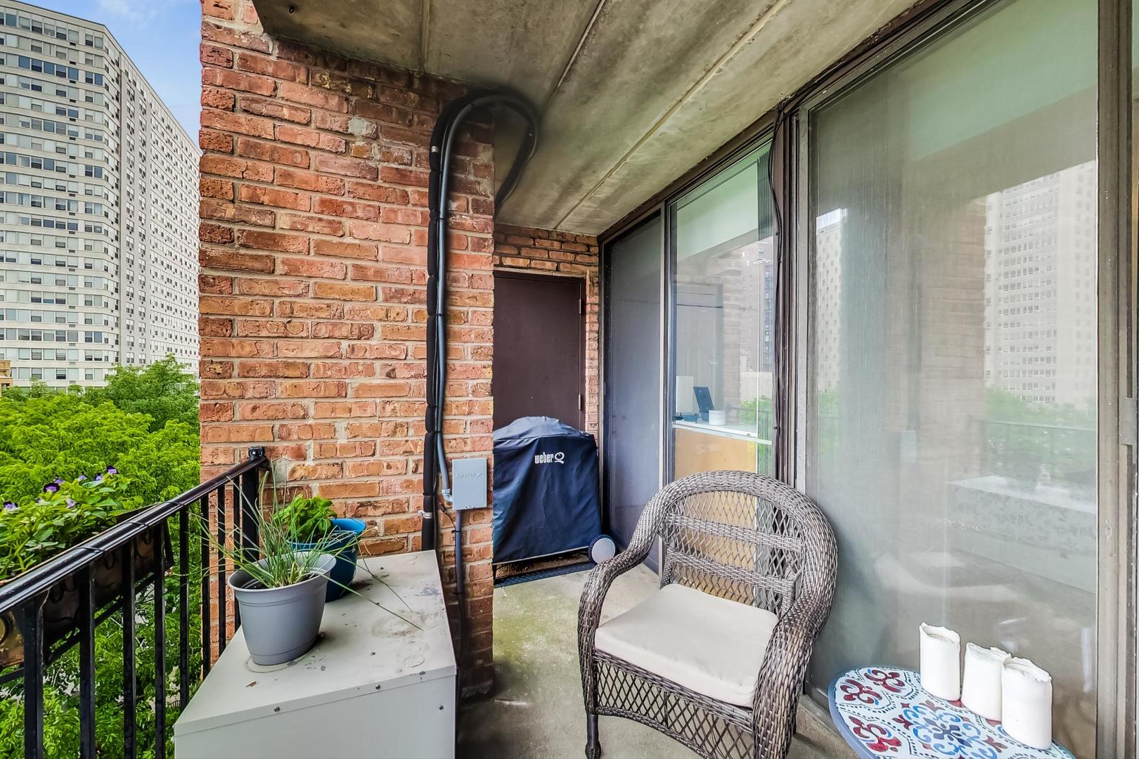 651 West Sheridan Road, Unit 7C Chicago, IL 60613 - Photo 24 of 27 a front view of a house with outdoor seating