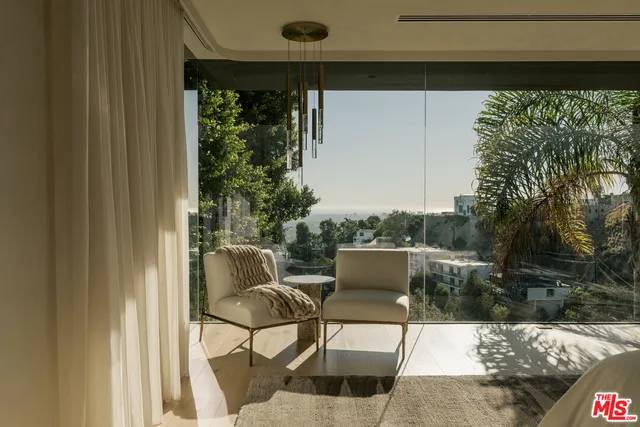 a view of a patio with table and chairs and potted plants