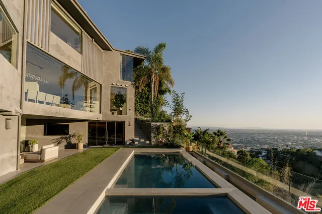 a view of swimming pool with outdoor seating and a potted plant