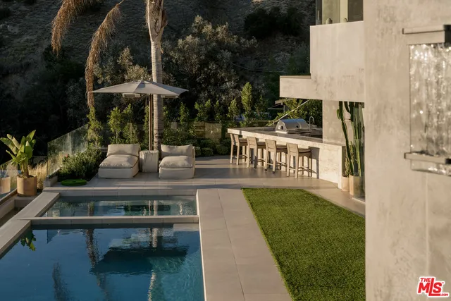 a view of a swimming pool and lounge chair