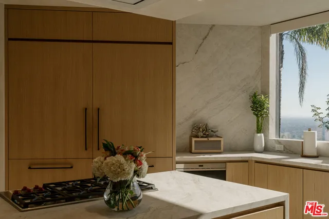 a kitchen with a refrigerator and a stove