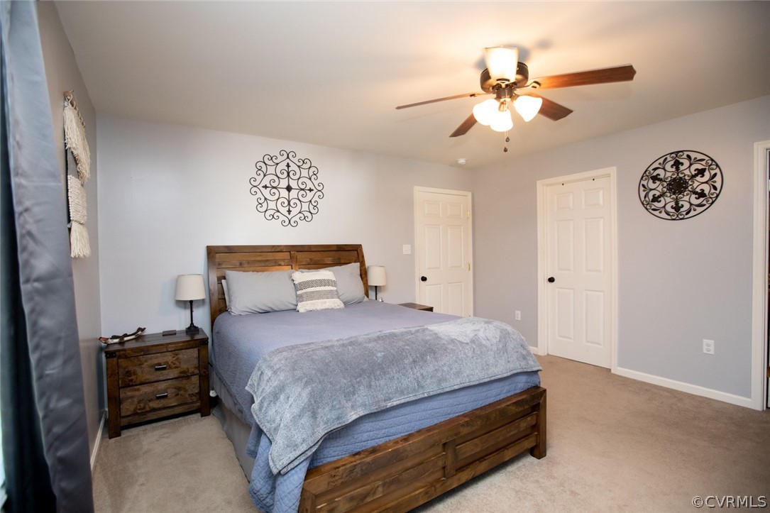 135 Mil-Scott Road Farmville, VA 23901 - Photo 20 of 46 a bedroom with a bed and a chandelier