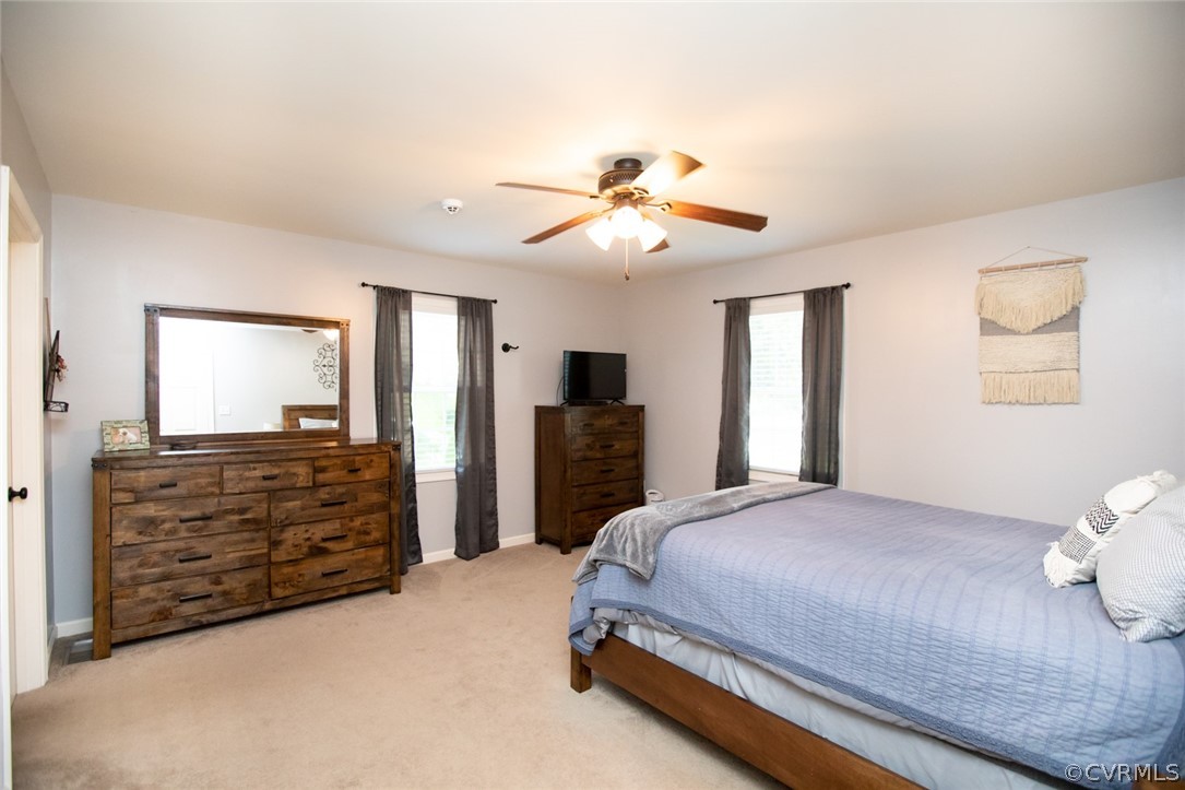 135 Mil-Scott Road Farmville, VA 23901 - Photo 21 of 46 a bedroom with a bed and a chandelier