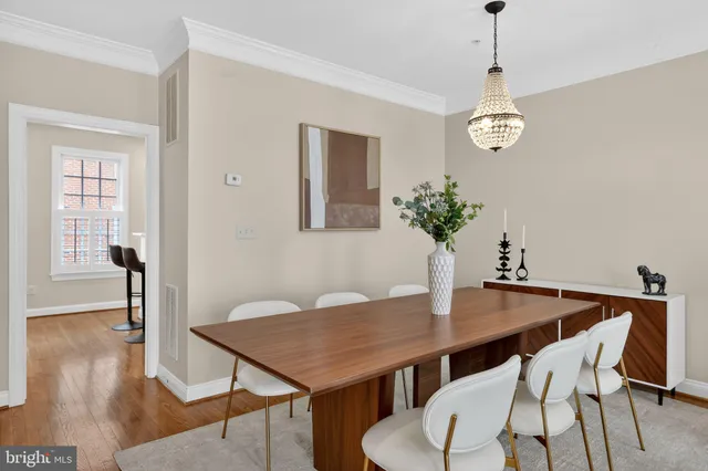 a view of a hallway with wooden floor and entryway