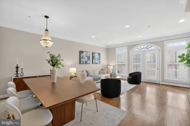 a living room with furniture a large window and a fireplace