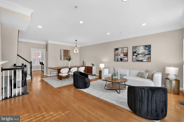 a view of a dining room with furniture wooden floor and a chandelier
