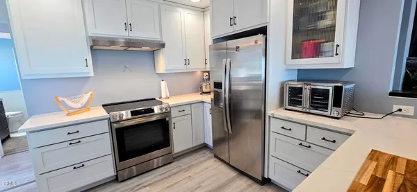 a kitchen with stainless steel appliances granite countertop a refrigerator stove and sink