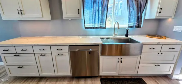 a kitchen with stainless steel appliances granite countertop a sink a stove and dishwasher