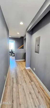a view of empty room with wooden floor