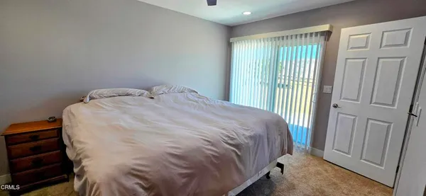 a bed sitting in a bedroom next to a window