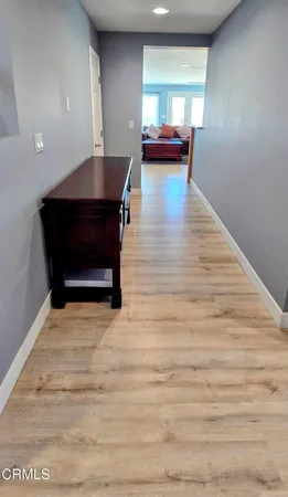 a room with wooden floor and furniture