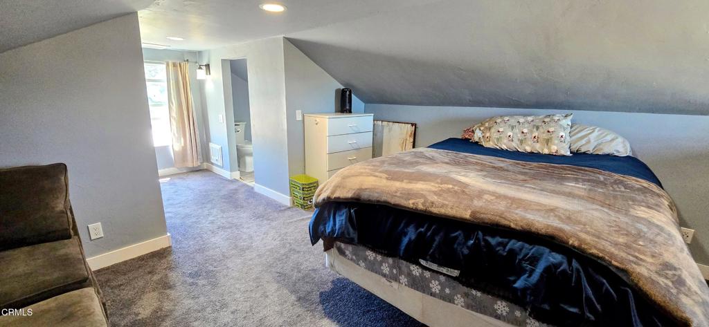 1834 East Carson Mesa Road Palmdale, CA 93550 - Photo 29 of 39 a bedroom with a bed and a window
