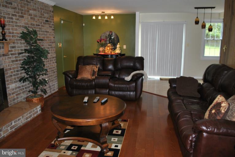 15317 Peach Orchard Road Silver Spring, MD 20905 - Photo 13 of 30 a dining room with furniture and wooden floor