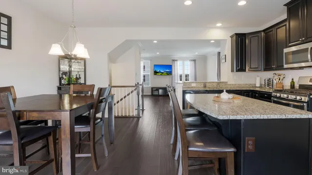 a kitchen with a dining table chairs and microwave