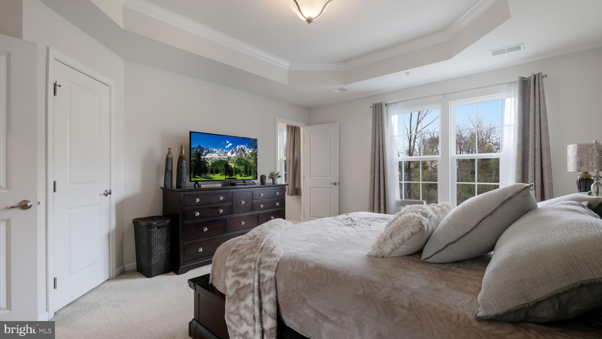 235 Ashburn Road Phoenixville, PA 19460 - Photo 19 of 31 a bedroom with a bed and a flat tv screen on dresser