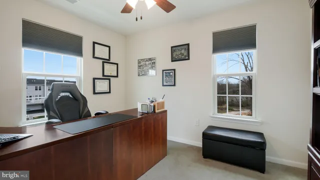 a living room with furniture a ceiling fan and a window