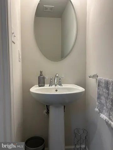 a bathroom with a sink and mirror