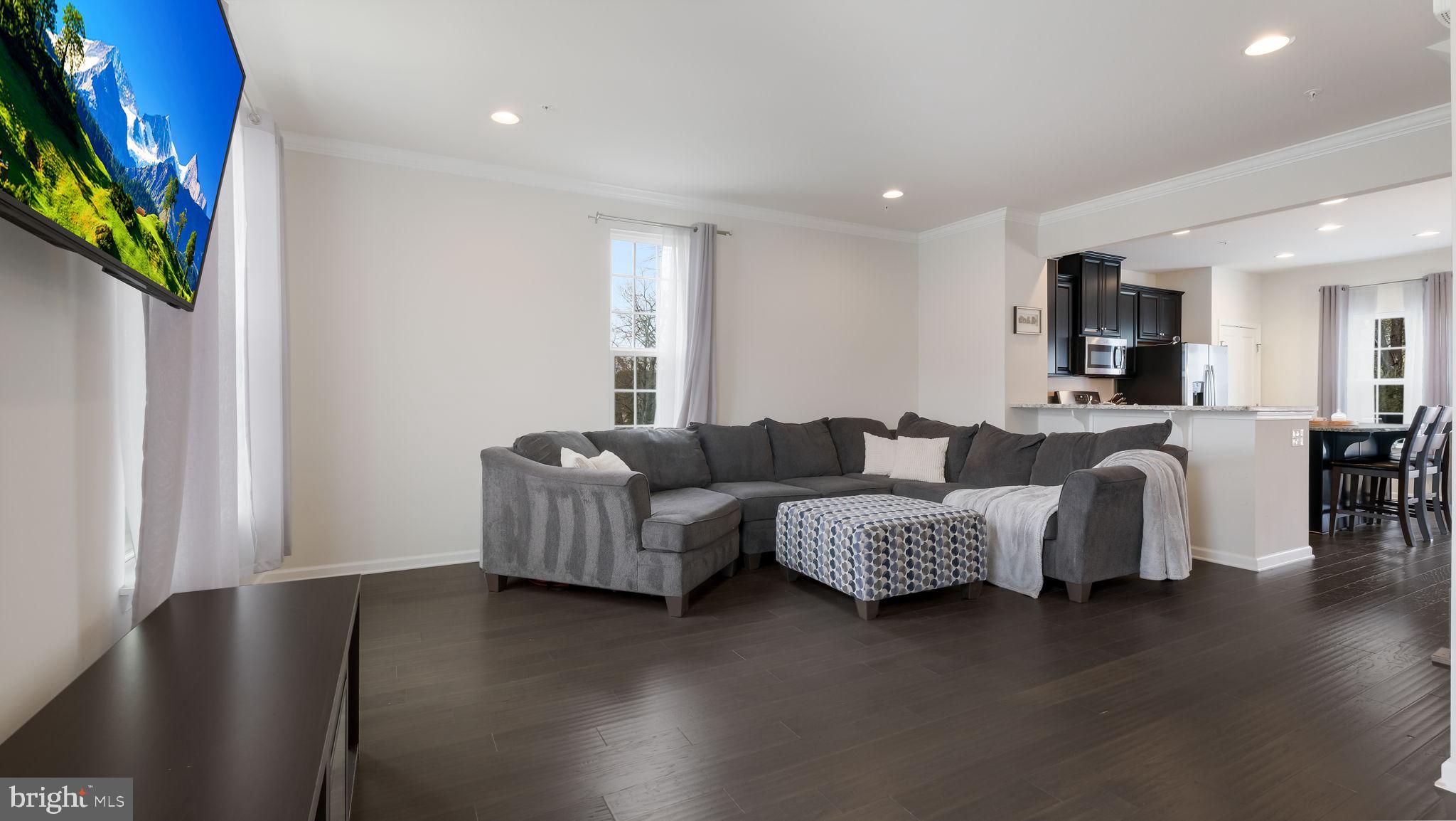 235 Ashburn Road Phoenixville, PA 19460 - Photo 9 of 31 a living room with furniture and a flat screen tv