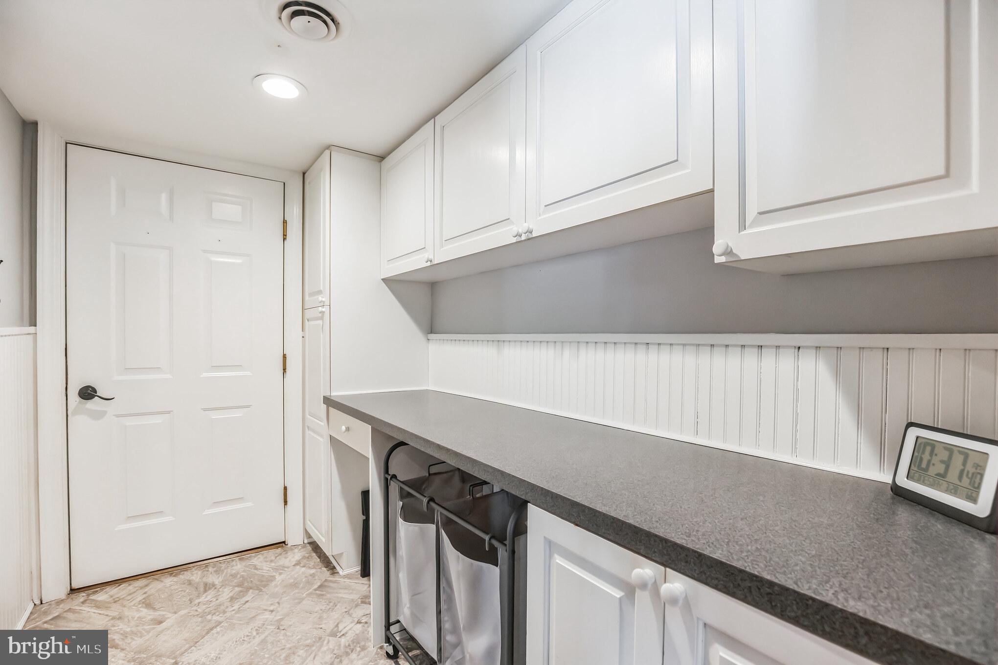 3310 Holland Cliffs Road Huntingtown, MD 20639 - Photo 21 of 40 a kitchen with a sink and cabinets