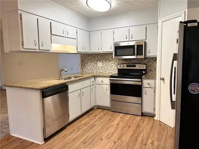 a refrigerator freezer sitting inside of a kitchen