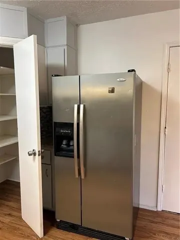 a kitchen with a refrigerator and a stove
