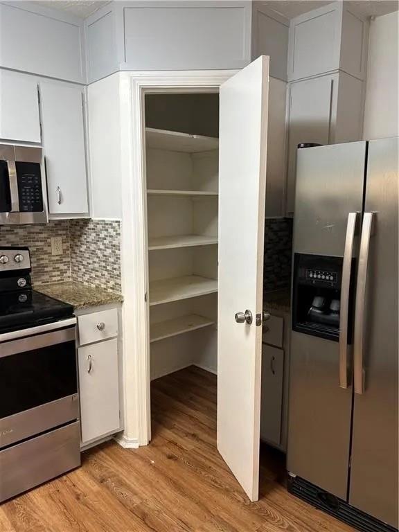 5490 Marbut Road Lithonia, GA 30058 - Photo 14 of 19 a kitchen with a refrigerator and a stove