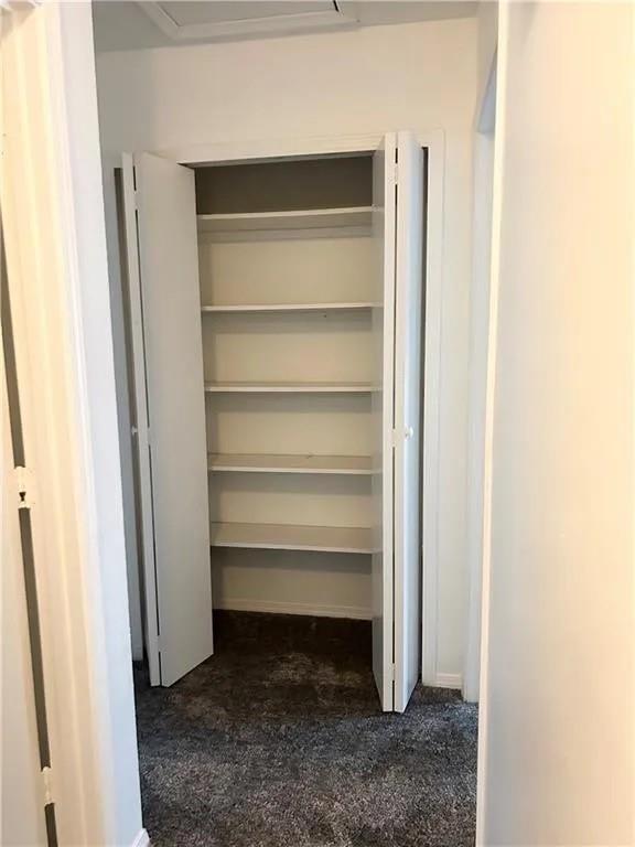 5490 Marbut Road Lithonia, GA 30058 - Photo 16 of 19 a view of walk in closet with empty racks