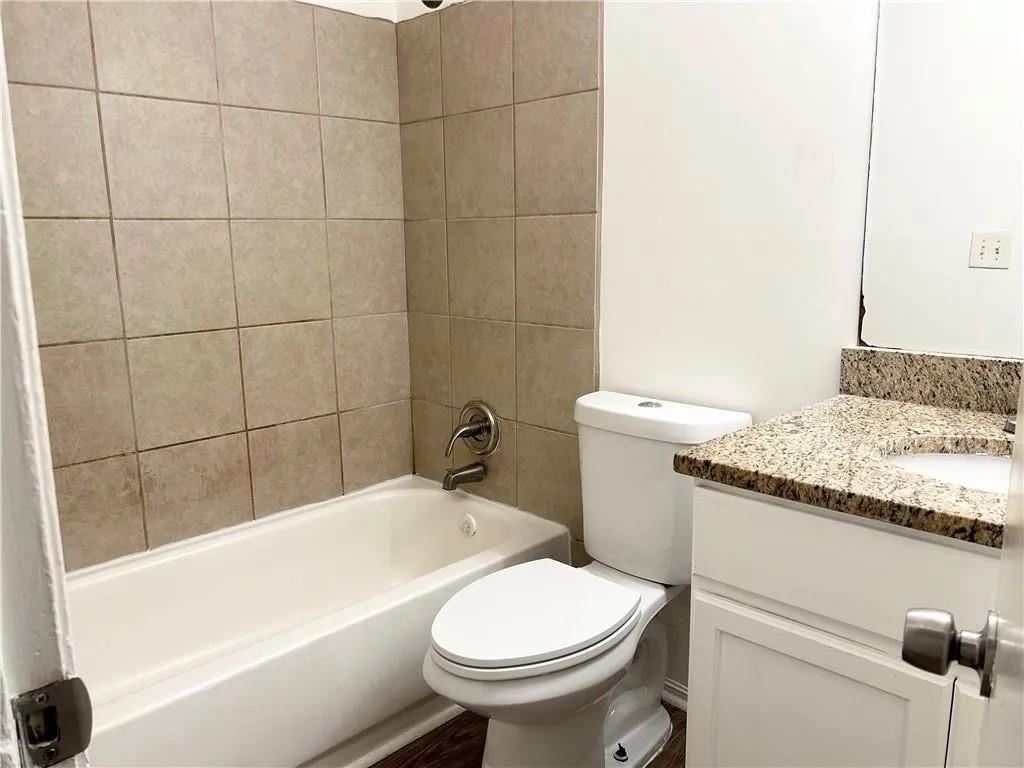 5490 Marbut Road Lithonia, GA 30058 - Photo 10 of 19 a bathroom with a granite countertop toilet and a bathtub