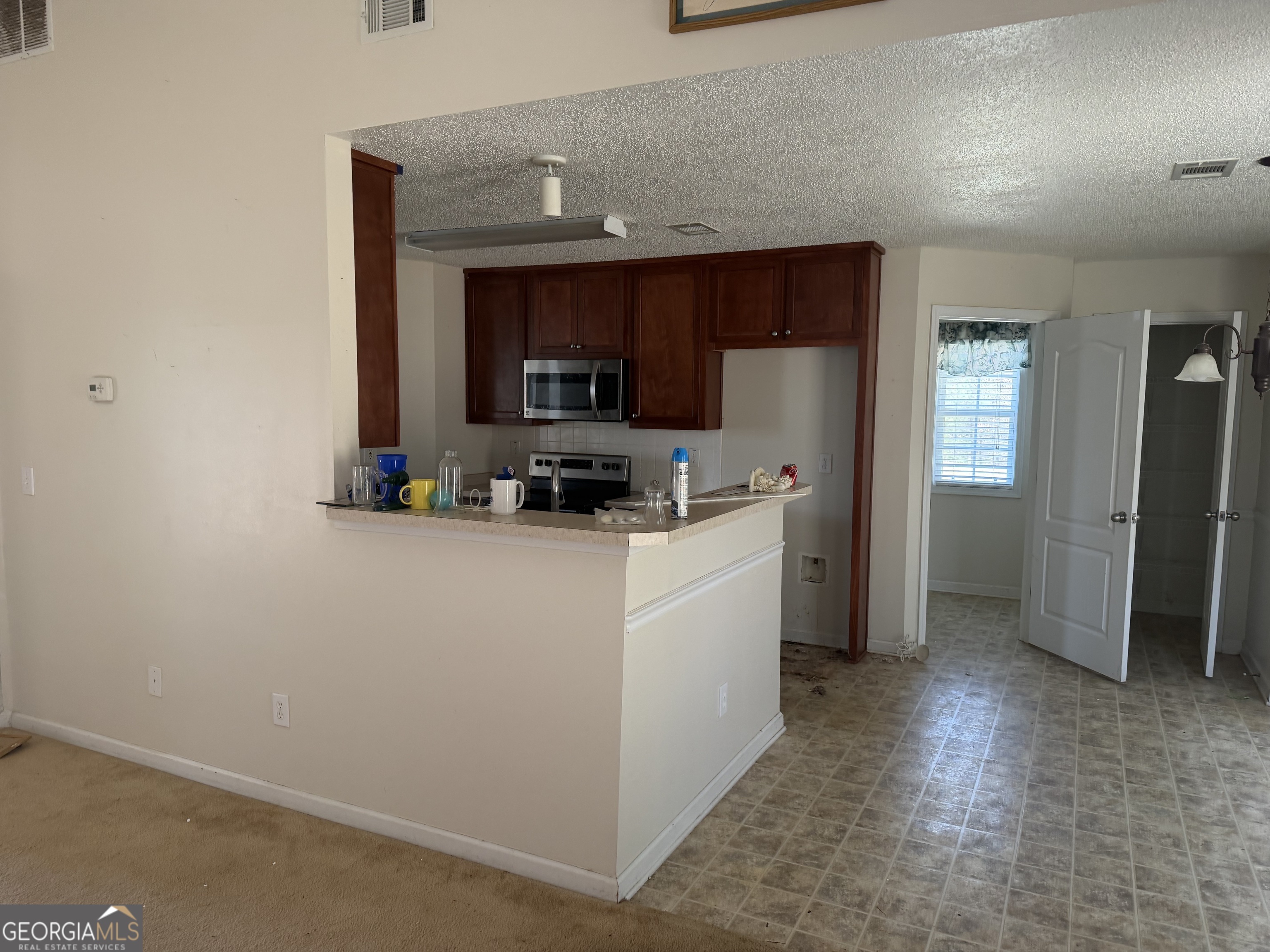 3868 Twin Ridge Lane Ellenwood, GA 30294 - Photo 6 of 16 a kitchen with a refrigerator a stove and a sink