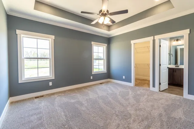 an empty room and chandelier fan