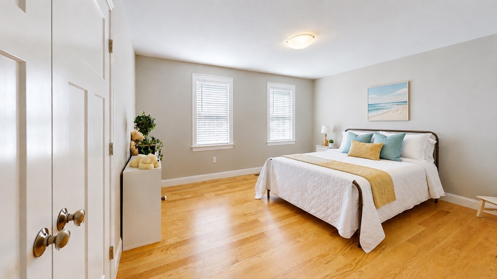 287 Wareham Street Middleboro, MA 02346 - Photo 16 of 28 a bedroom with a bed and wooden floor