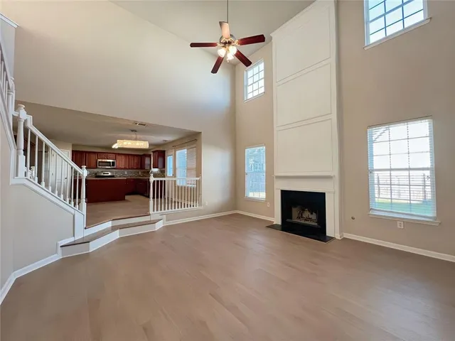 a kitchen with stainless steel appliances granite countertop a stove a sink dishwasher a refrigerator and a microwave