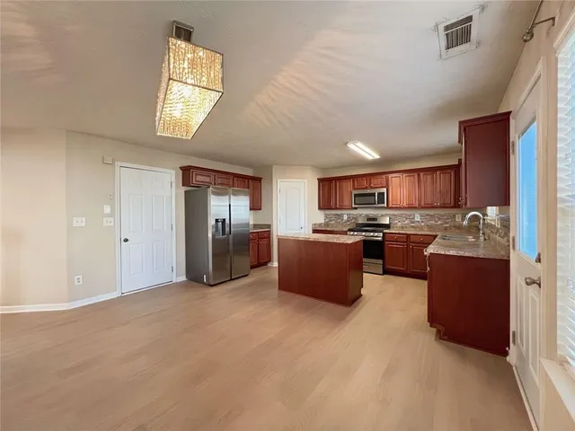 a stove top oven sitting inside of a kitchen