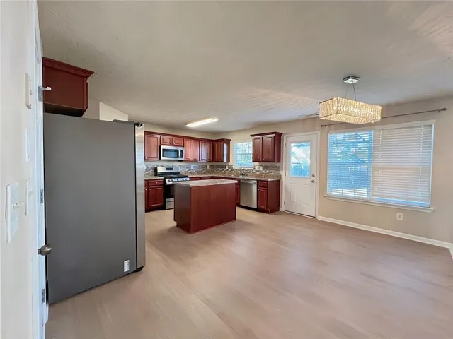 a kitchen with granite countertop a sink and a wooden cabinets