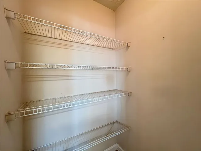 a view of a livingroom with wooden floor and windows