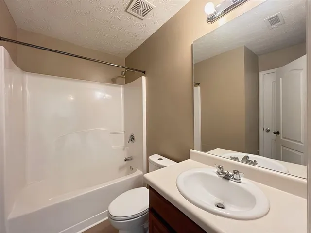 a view of a livingroom with a ceiling fan and hardwood floor