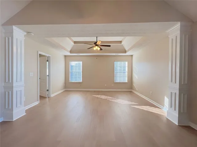 a view of a room with wooden floor